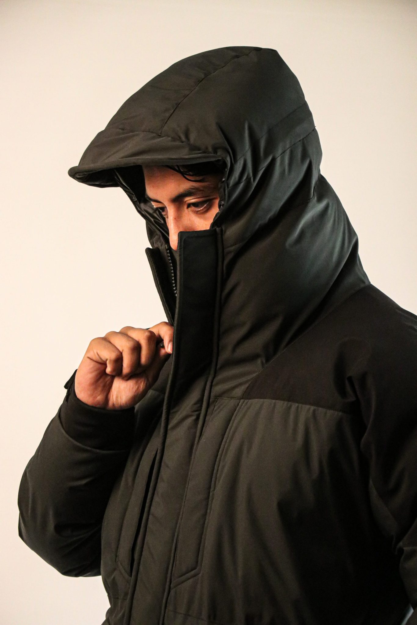 Hooded outdoor jacket worn in a portrait
